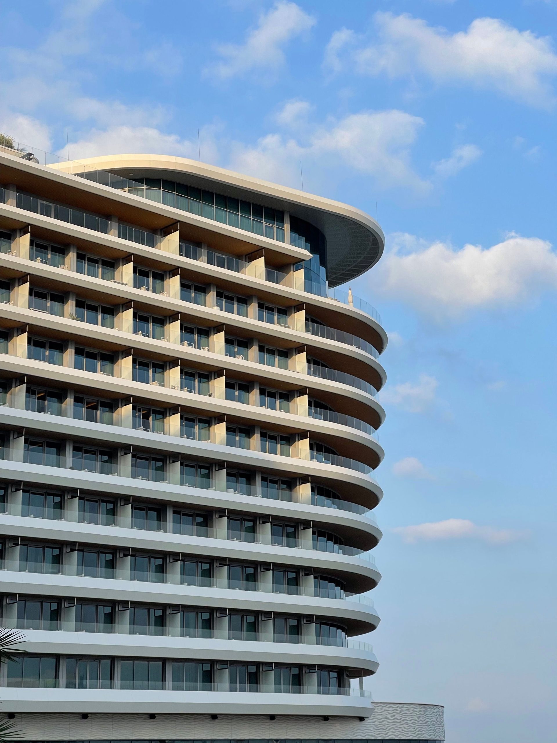 Elegant hotel exterior under blue sky, ideal for travel and tourism imagery.