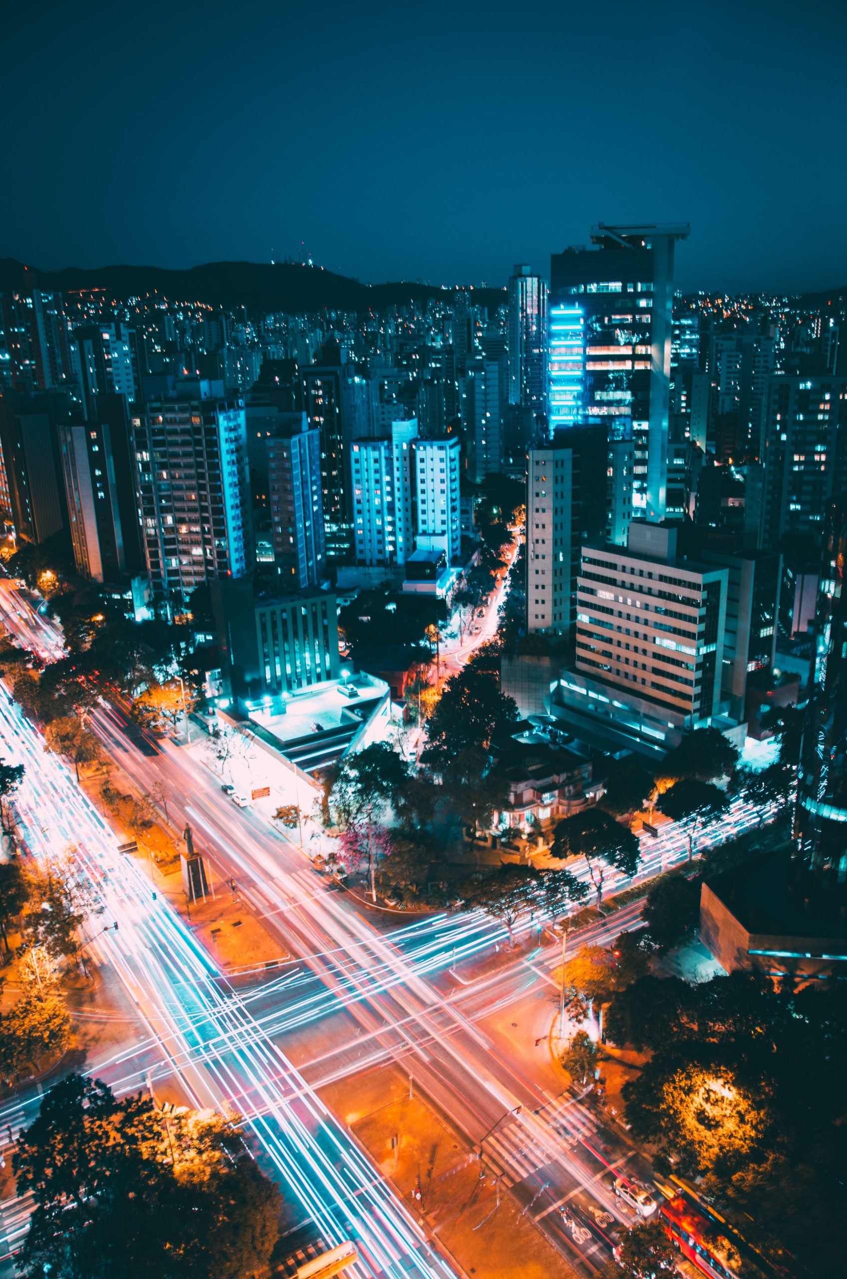 Breathtaking aerial view of Belo Horizonte with vibrant light trails at night, showcasing urban city life.