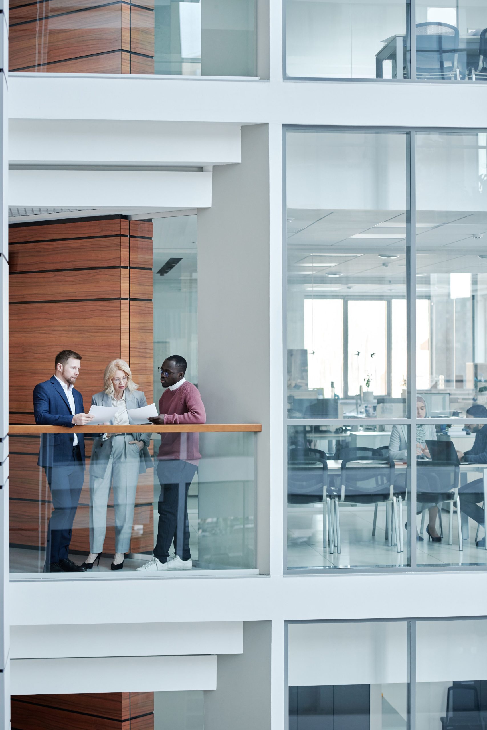 Business professionals discussing strategy in an open office environment with contemporary design.